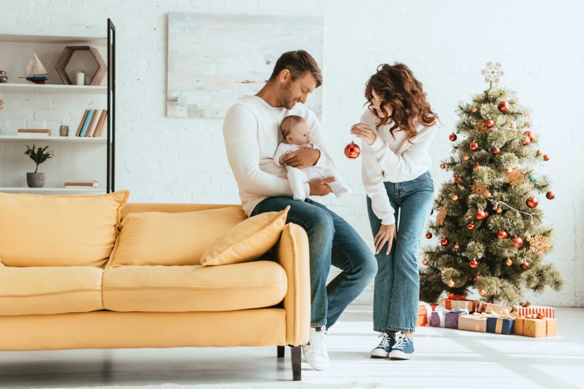 christmas-tree-little-family-with-baby-on-sofa-decorating-tree